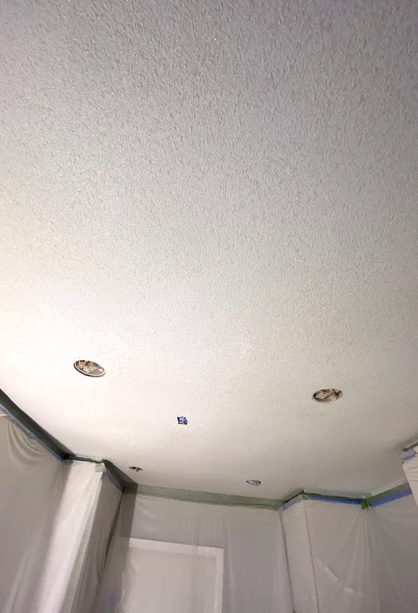 Patched drywall hole in Aliso Viejo, surface skimmed and blended to a smooth, flat finish with no visible seams or shadows.