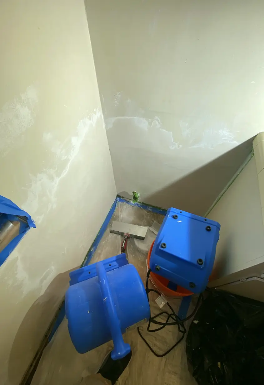 Patched medium hole in drywall now blended smoothly with wall, no seams or shadows, surface looks flat and even under natural light.