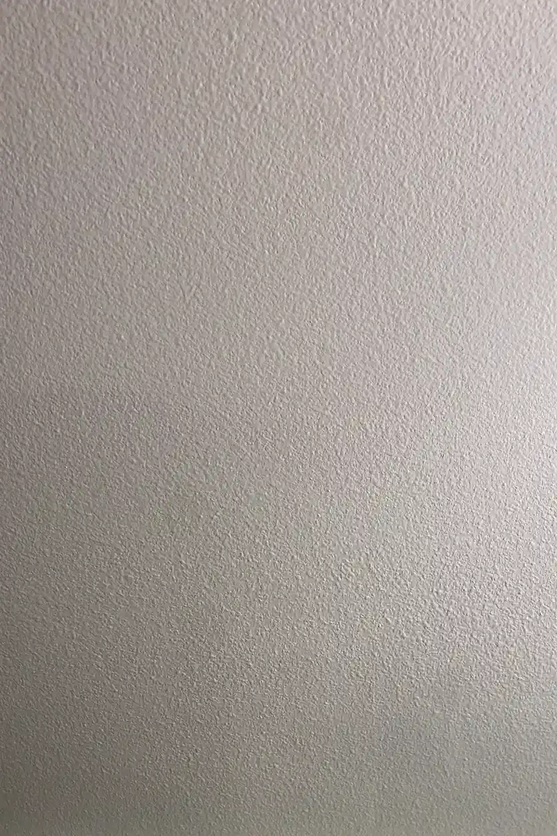 Drywall patch in Aliso Viejo showing a repaired hole now smooth and blended, with no seams or shadows visible on the flat surface.