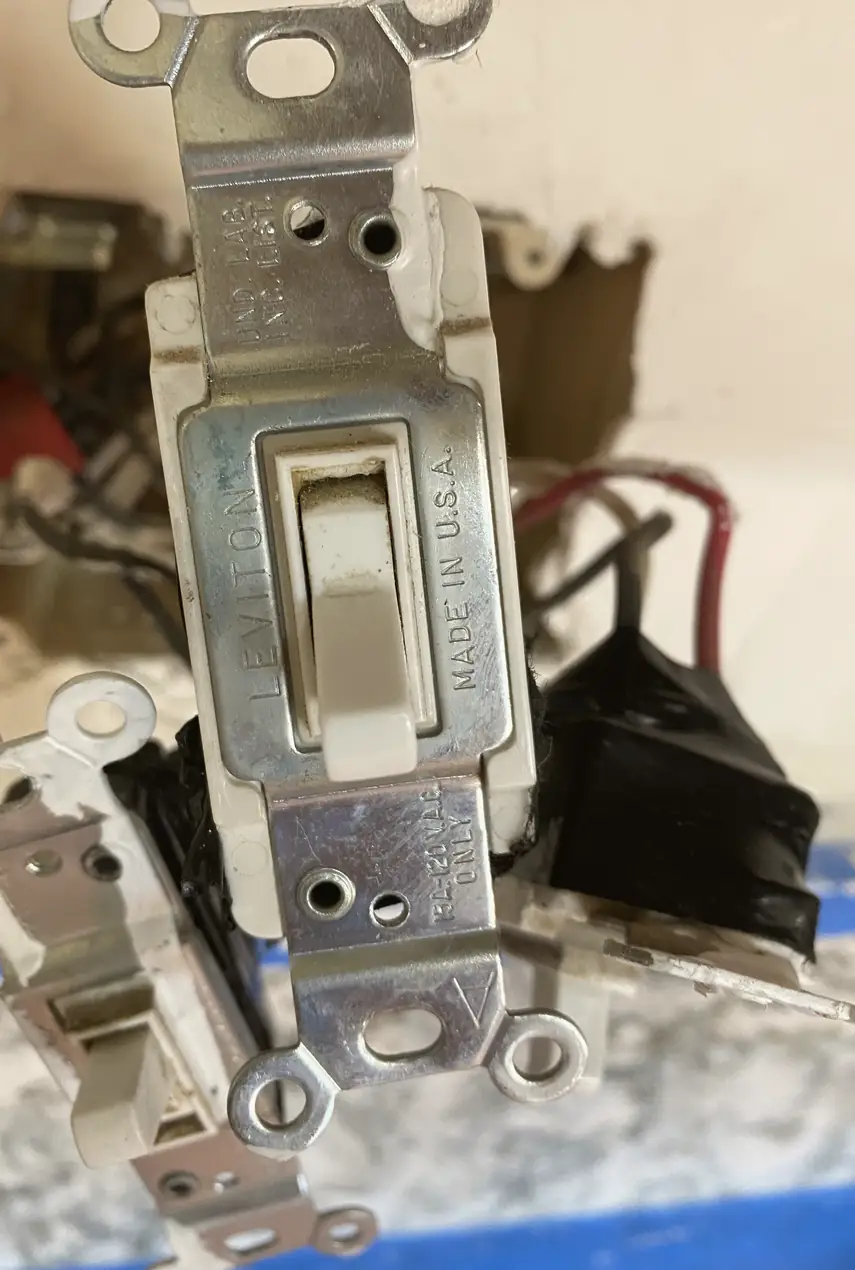 Repaired drywall with a previously rough patch now skimmed smooth and blended, showing an even surface with no visible seams or shadows.