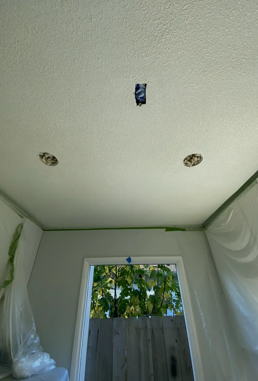 Hole patched and rebuilt with smooth drywall, blended seamlessly into the wall with even light and no visible seams.