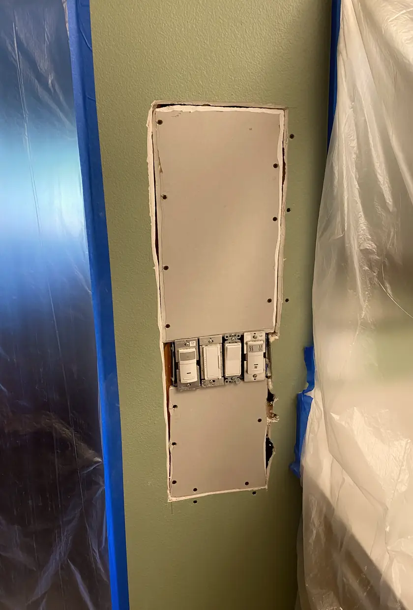 Drywall hole patched and skimmed smooth, wall surface fully blended with no visible seams or shadows in Buena Park home.