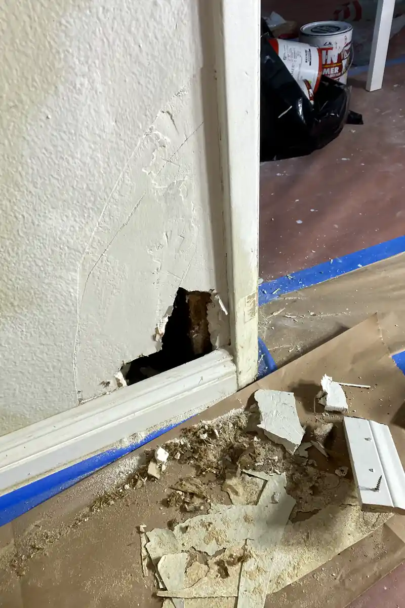 A previously damaged drywall with a large hole now patched and skimmed, showing a smooth, flat surface with no visible seams or shadows.