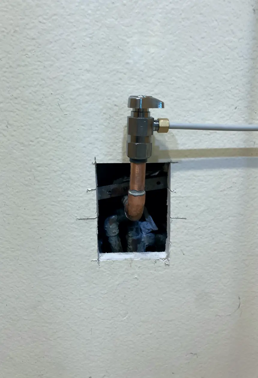 Patched drywall hole in Cypress, smooth surface blended with surrounding wall, no visible seams or shadows in natural light