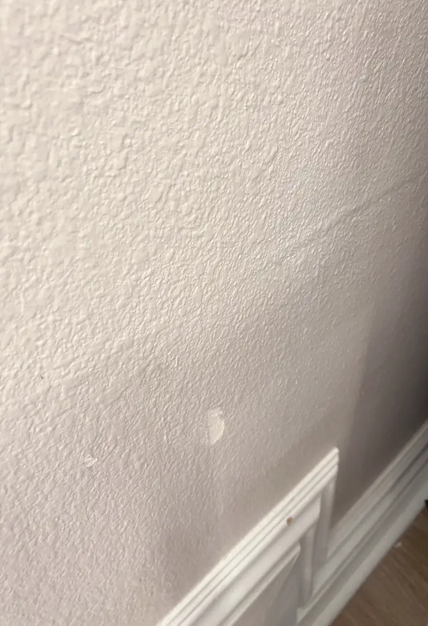 A repaired drywall hole in Dana Point, now a smooth flat wall without visible seams or shadows.