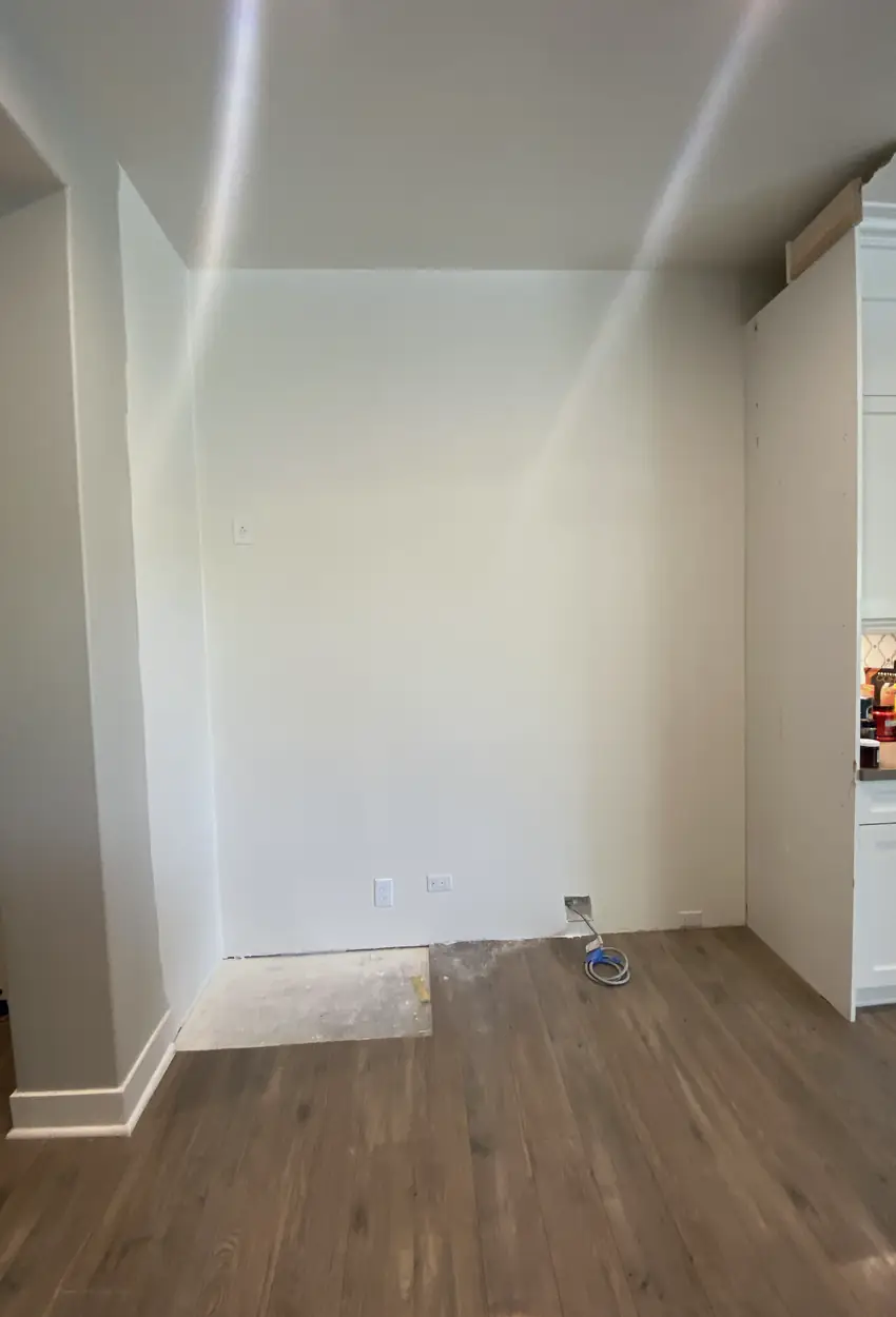 Patched drywall hole in Fullerton, now smooth and blended with no visible seams or shadows on the wall.