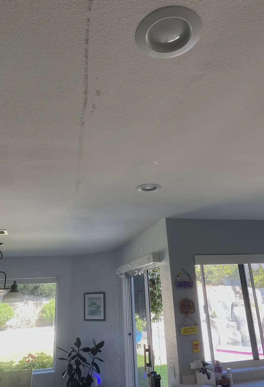 Patched large hole in drywall with a smooth, flat surface that blends seamlessly with surrounding wall, showing no visible seams or shadows.