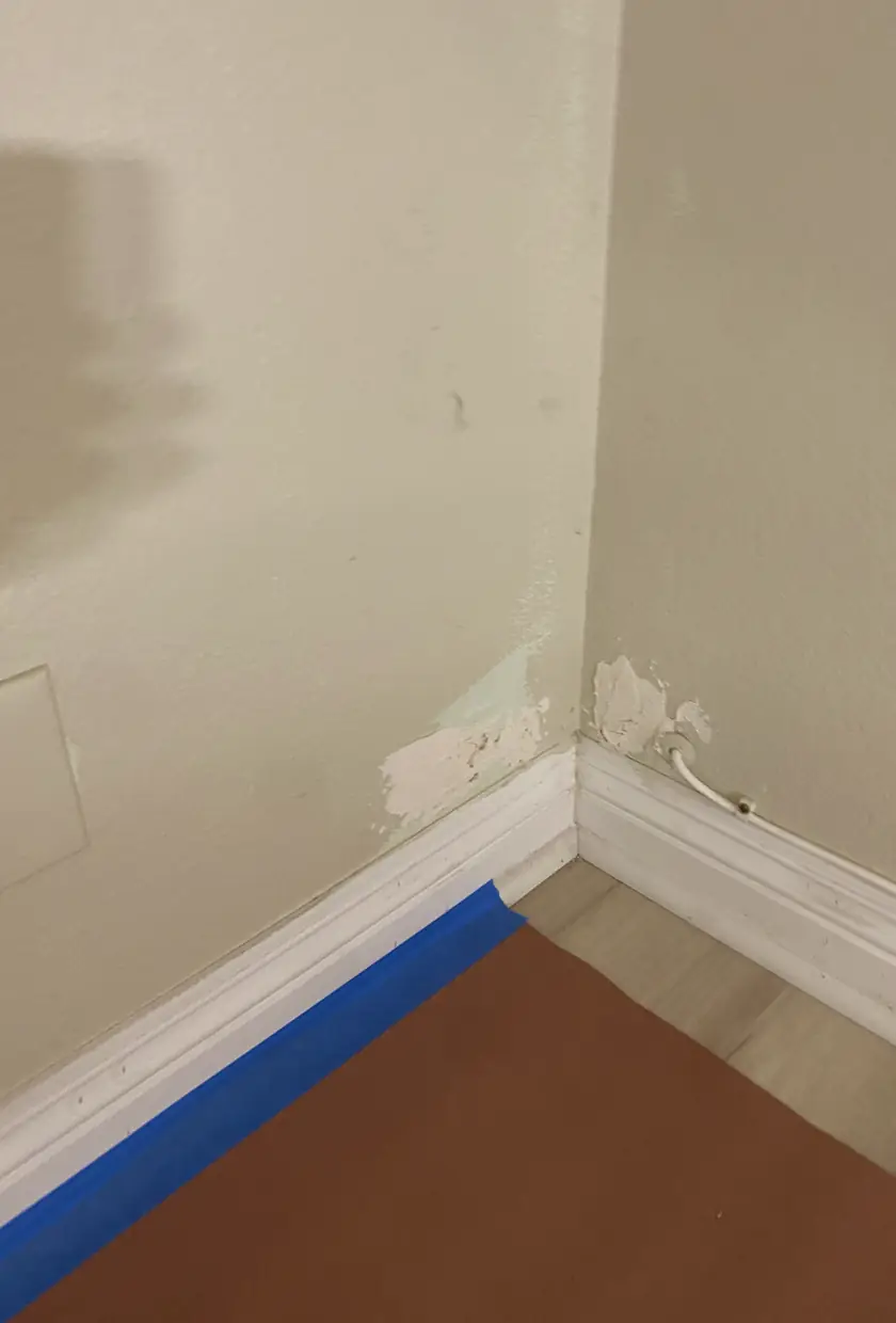 Seamlessly patched drywall hole in Fullerton home, surface skimmed smooth with no visible seams or shadows.