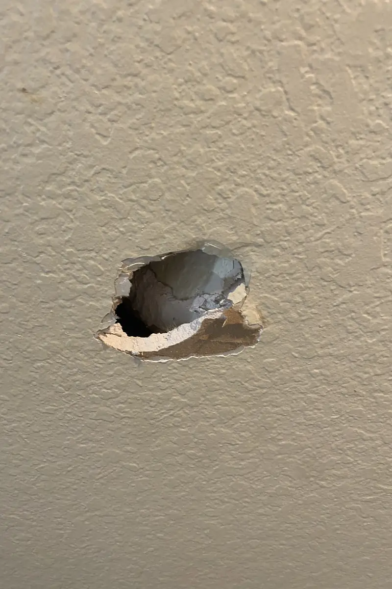 Patched drywall hole in Garden Grove home with a smooth, even surface, no seams, and natural light showing a blended finish.