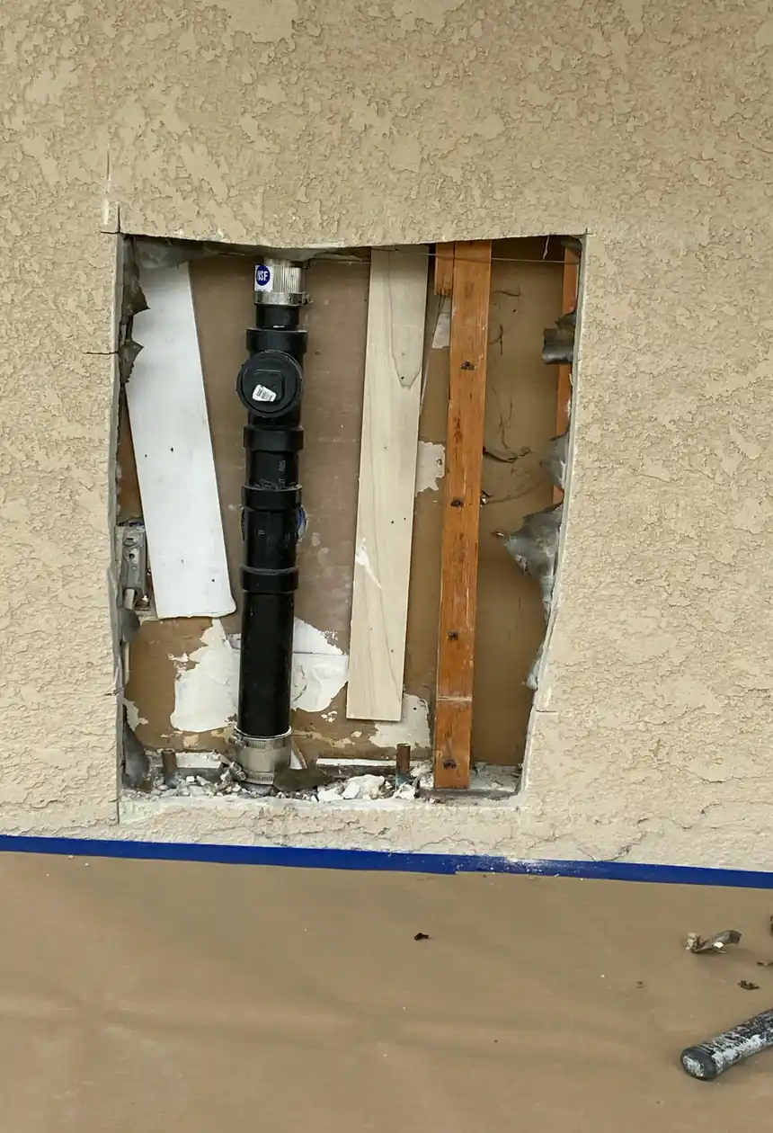 Repaired drywall with a large hole patched and skimmed to a smooth, even surface, showing no visible seams or texture differences.