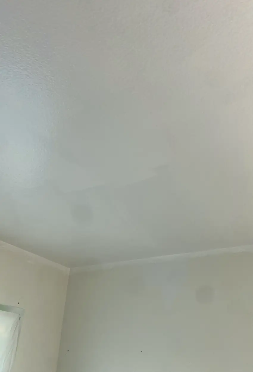 Wall with a patched hole now smooth and flat with no visible seams or shadows, perfectly blending with surrounding drywall.