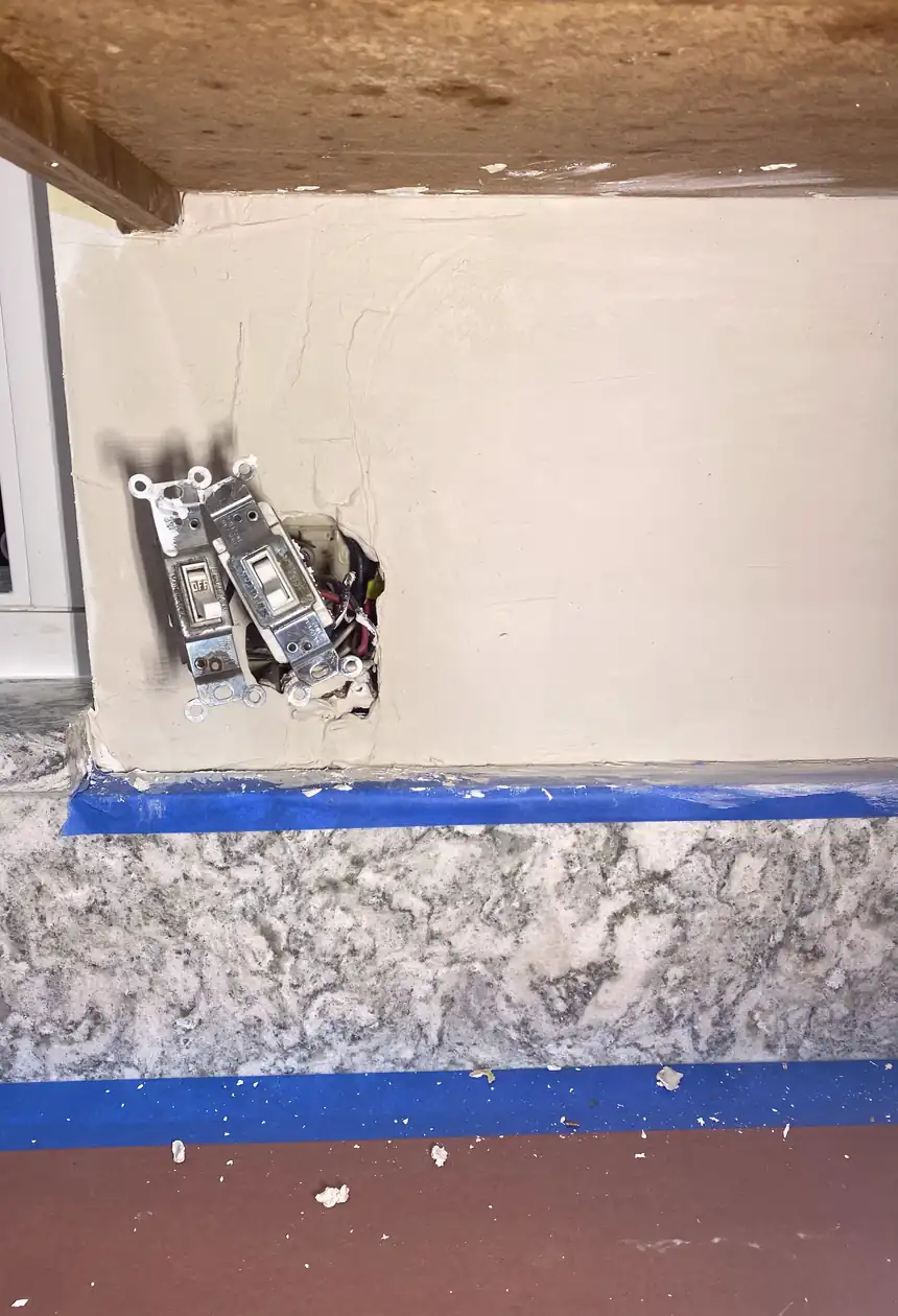 Repaired large hole in drywall, surface skimmed smooth and painted to match, wall now flat with no visible seams or shadows.