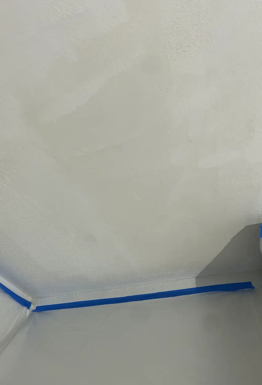 Patched drywall hole in La Palma now smooth and evenly blended with surrounding wall, no visible seams or rough patches.