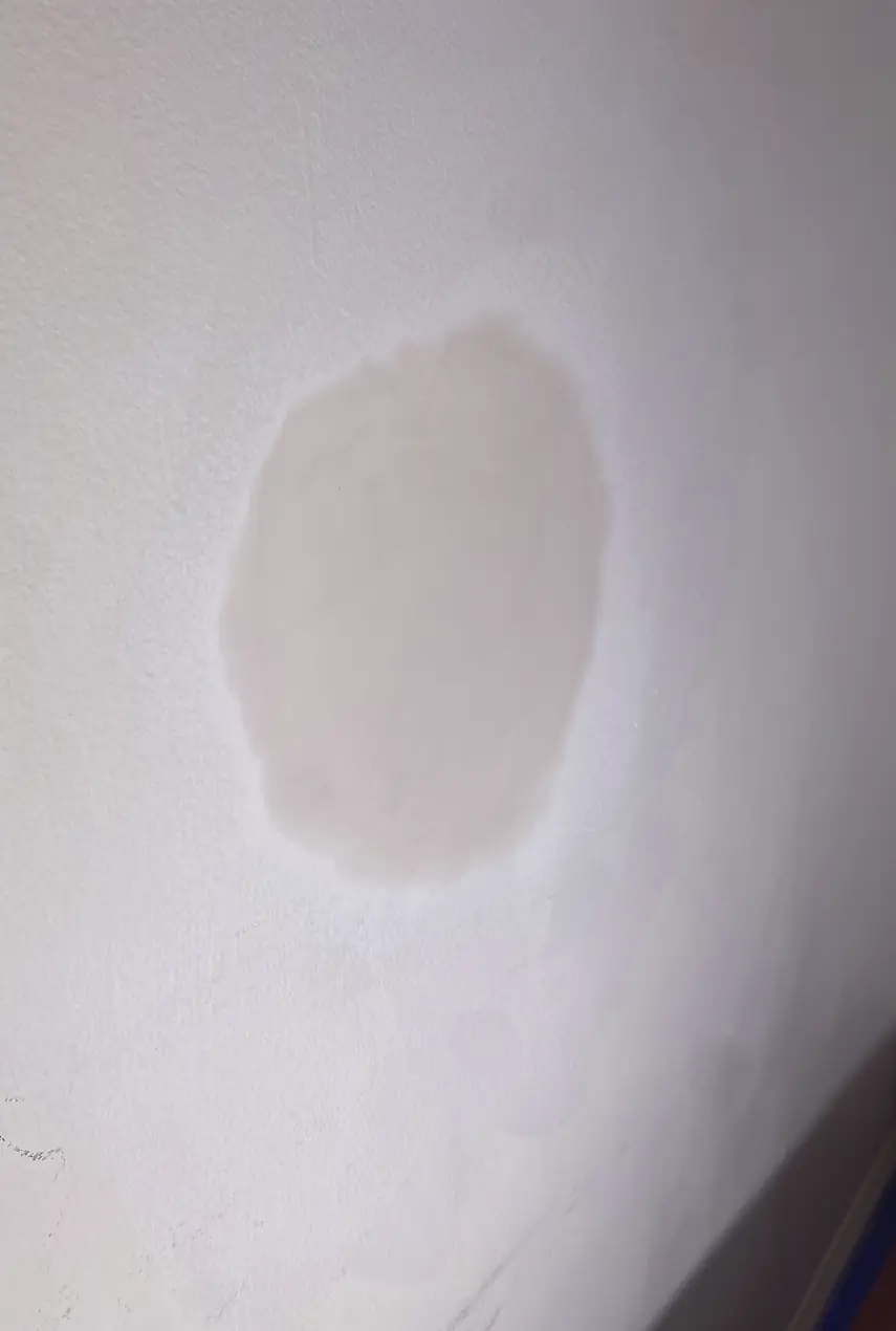 Repaired drywall where a large hole was patched and skimmed to a smooth, even surface with no visible seams or shadows.