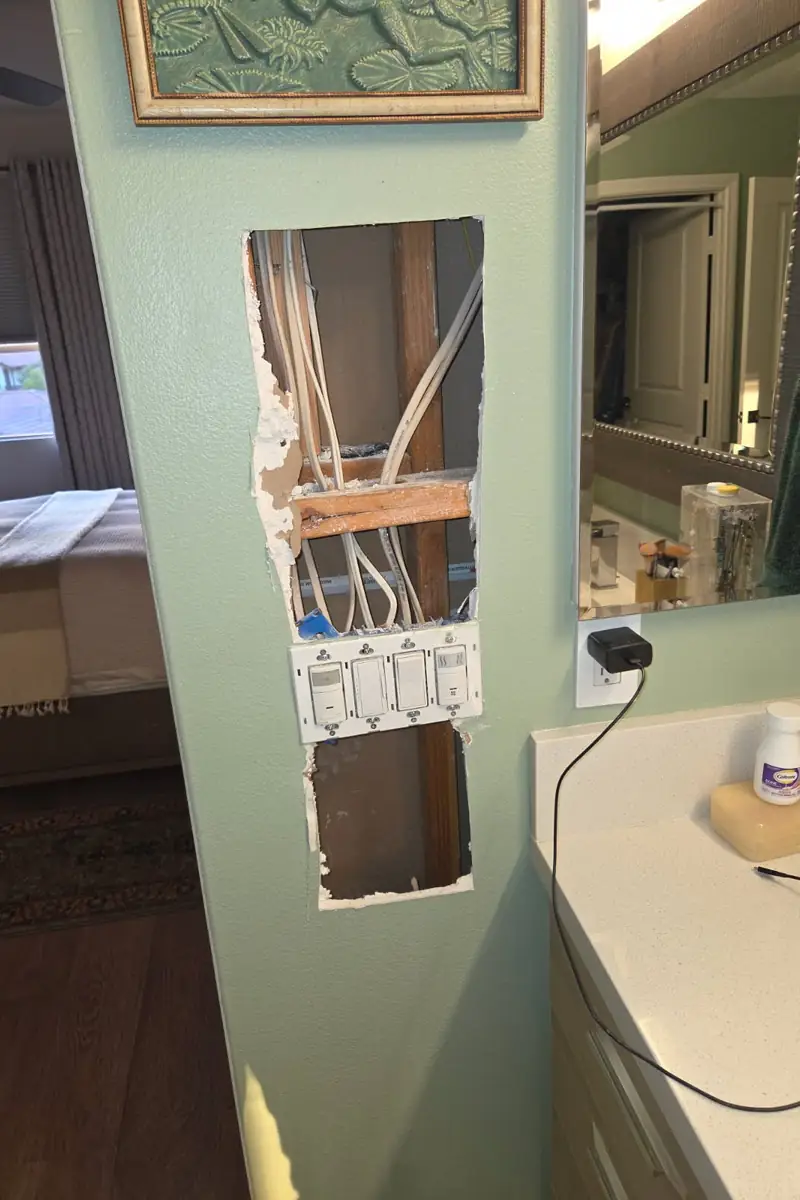 Patched drywall hole in Laguna Beach home, surface skimmed and blended, resulting in smooth, flat finish with natural light evenly spread.