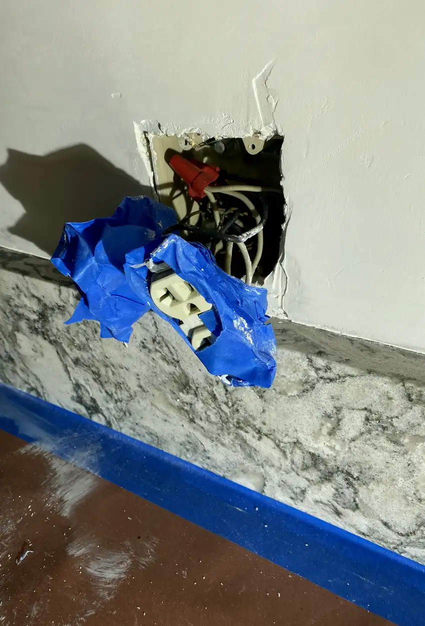 Repaired drywall hole now smoothly patched and blended with the surrounding wall, presenting an even, flat surface without shadows or seams.