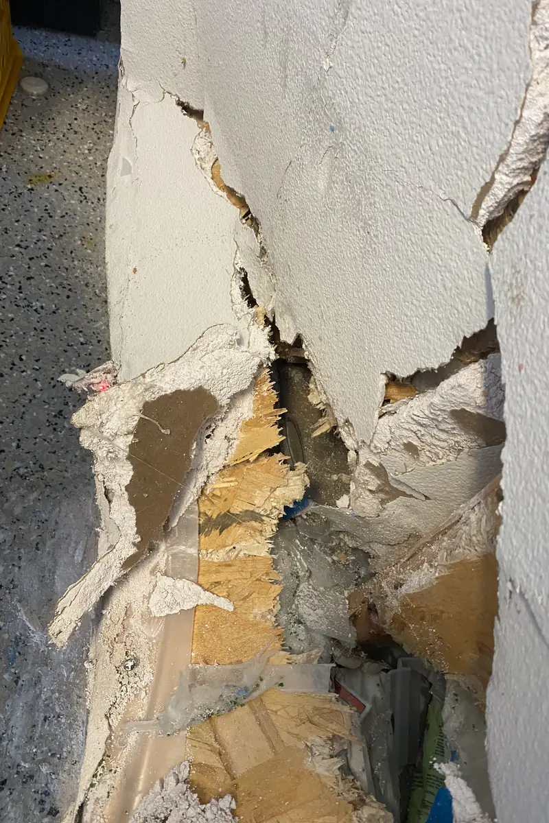 Repaired drywall where a large hole was patched and skimmed; surface looks smooth with no visible seams or shadows.