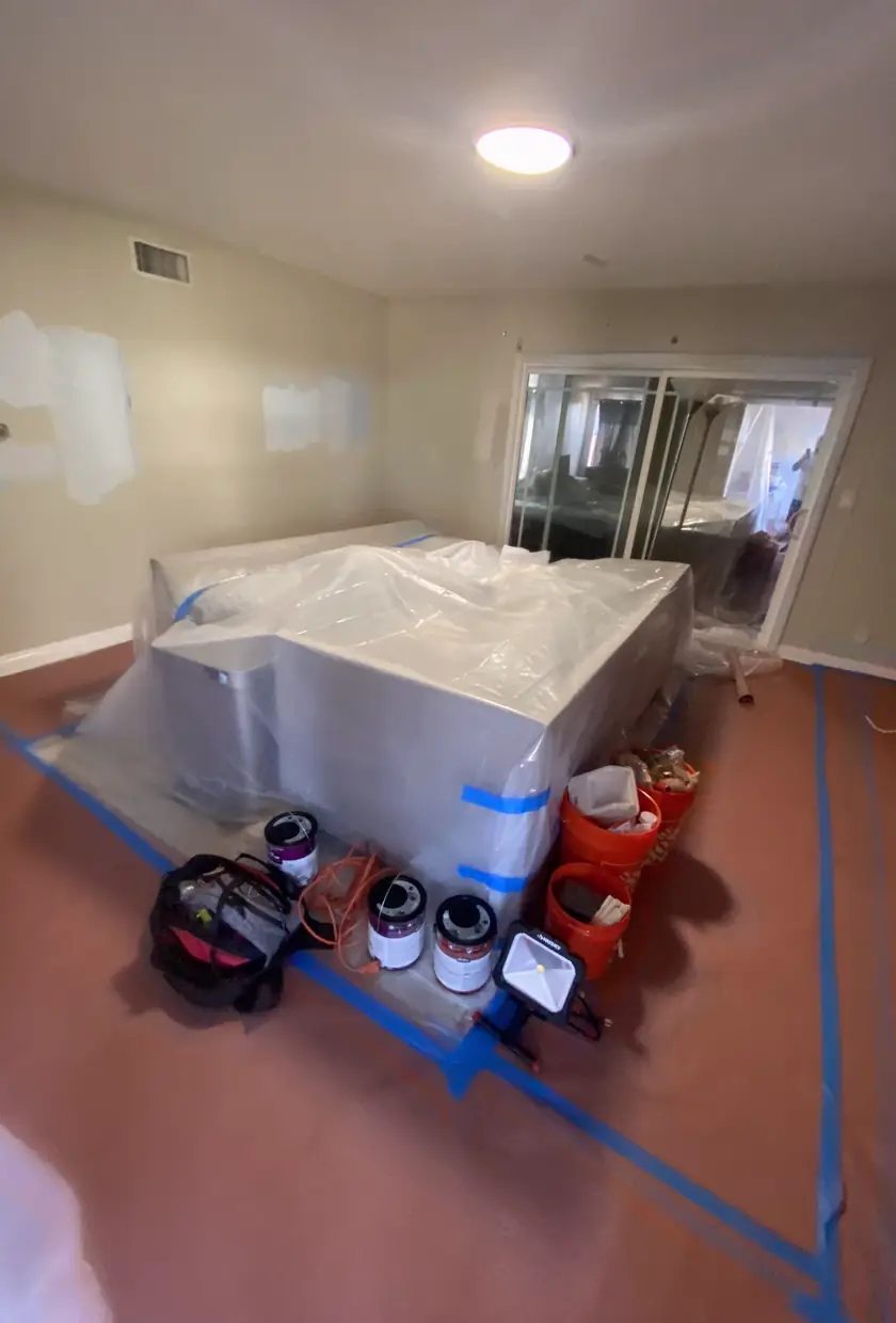 Drywall hole patched and skimmed to a smooth, seamless finish with even natural light highlighting the flat surface.