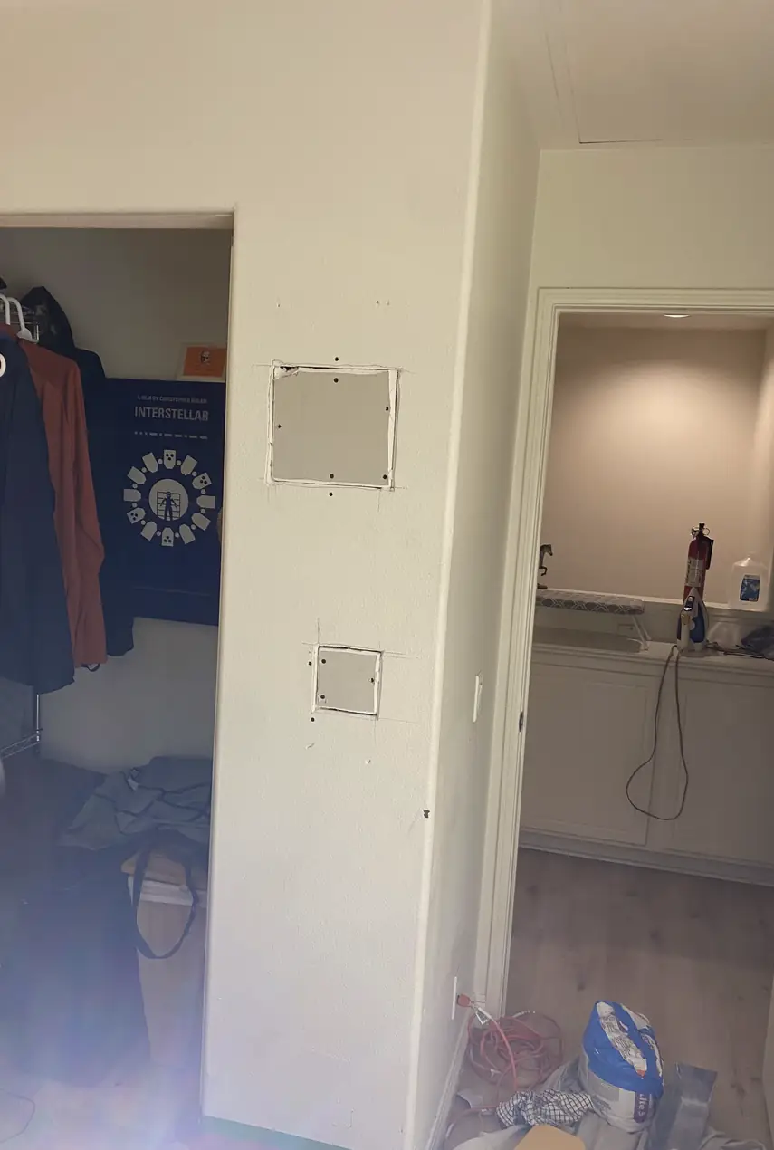 Repaired drywall where a large hole was patched and skimmed to a smooth, even surface with no visible seams or shadows.