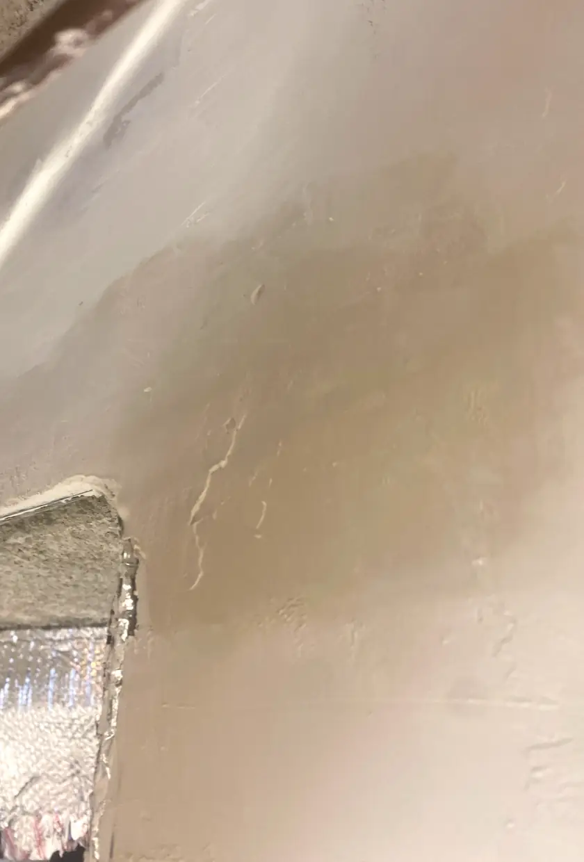 Repaired cracked drywall area now smooth and flat with no visible seams, natural light highlights even surface in Mission Viejo home.