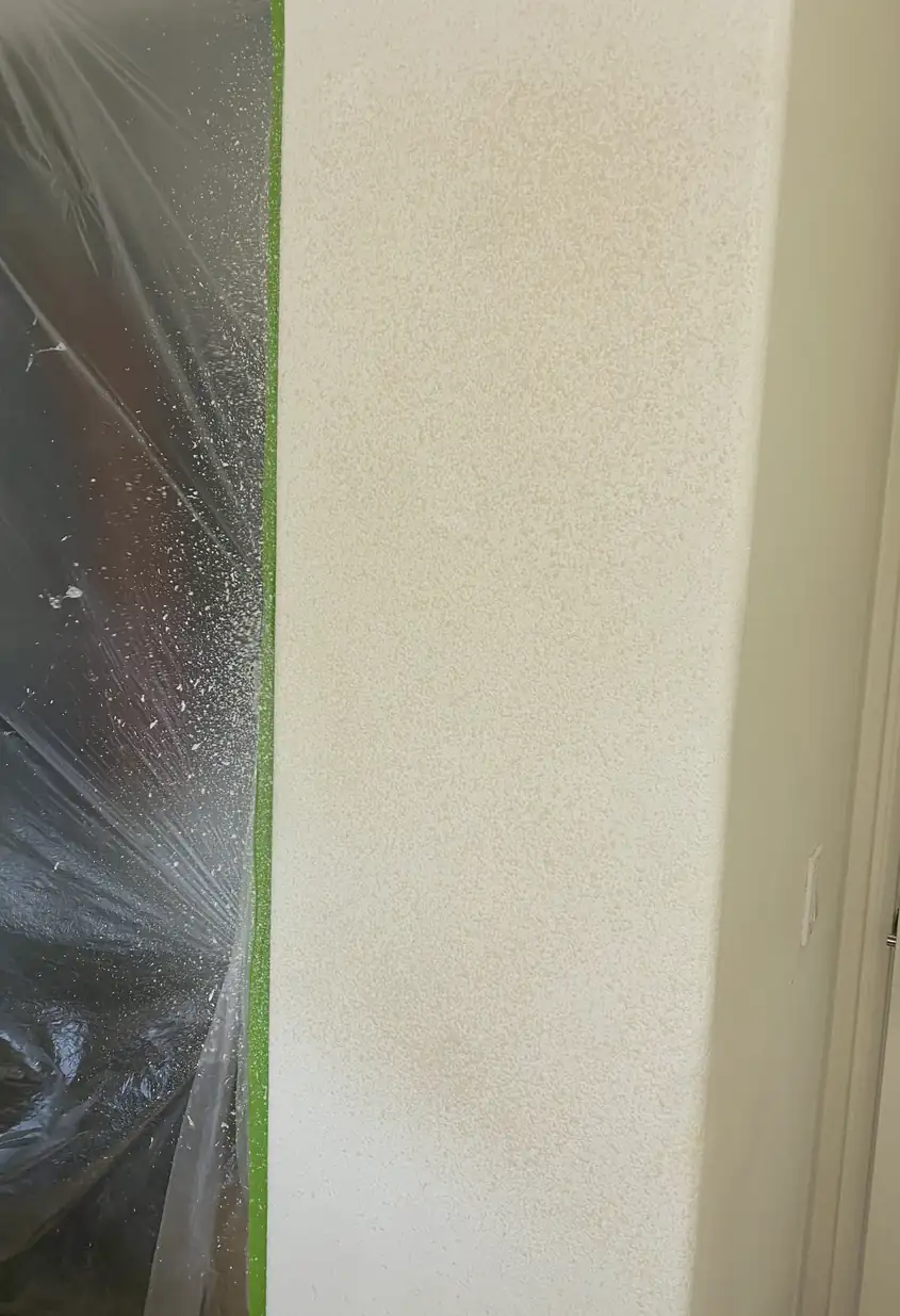 Repaired drywall hole patched and skimmed smooth with no visible seams, surface evenly blended under soft natural light.