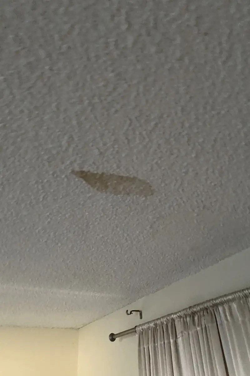 Repaired drywall where a large hole was patched and skimmed, now a smooth and flat wall with no visible seams or shadows.