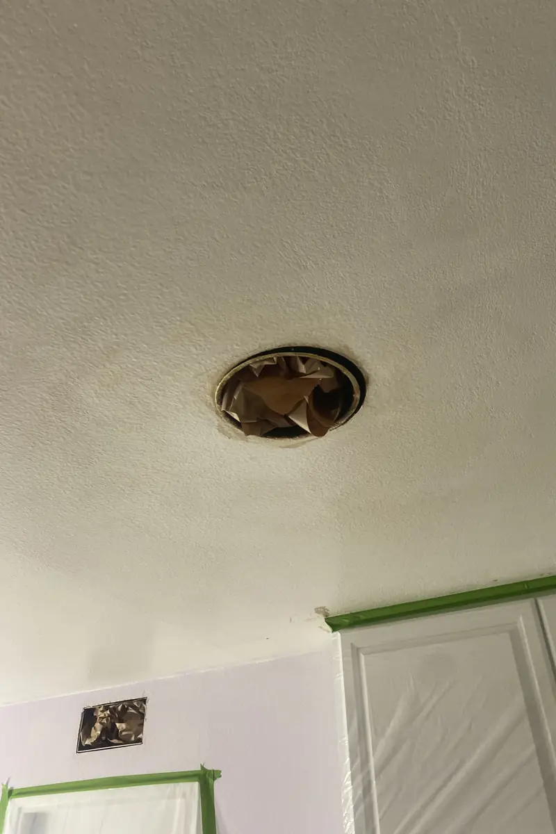 Smoothly patched drywall where a large hole was rebuilt and blended to a flat, even surface with no visible seams or shadows.