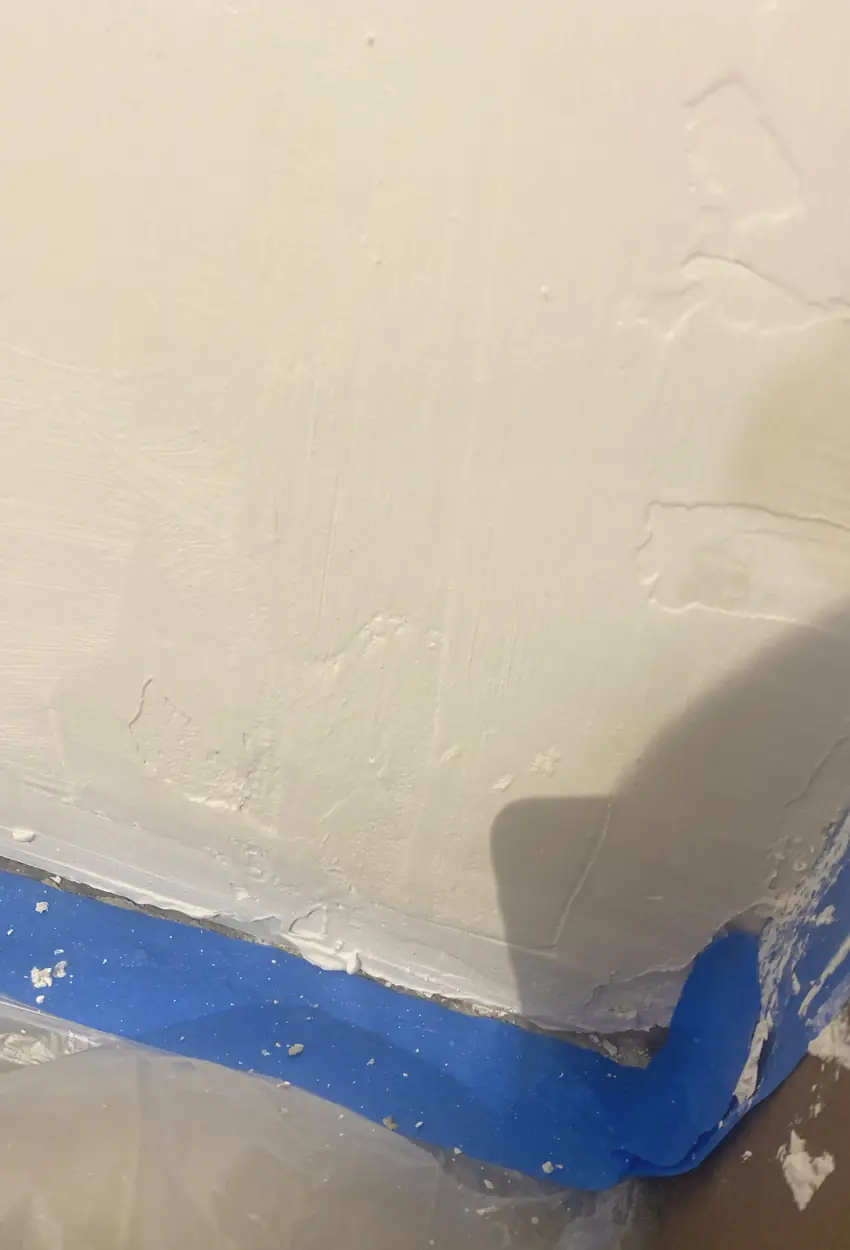 Seamlessly patched drywall with no cracks or holes, surface smooth and even under natural light in Orange room.