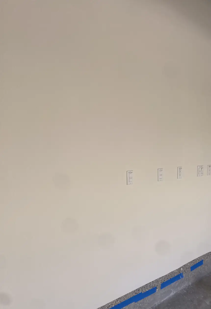 Wall hole patched and skimmed smooth with no visible seams, natural light highlighting the even surface in Orange room.