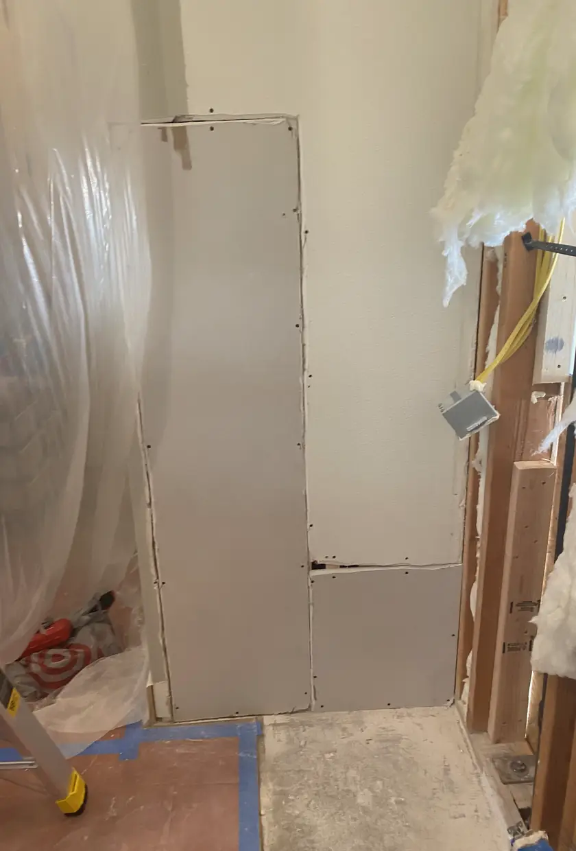 Repaired drywall where rough patch was, now flat and smooth with no visible seams or shadows in San Juan Capistrano home.