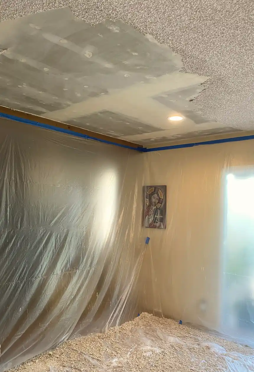 Wall section where a large hole was patched and the drywall surface is now smooth and evenly blended with surrounding texture