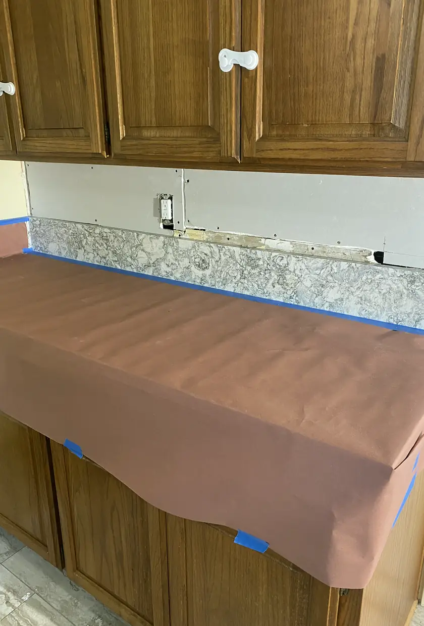 Repaired drywall with a previously large hole now fully patched and blended, surface smooth and even with natural light.