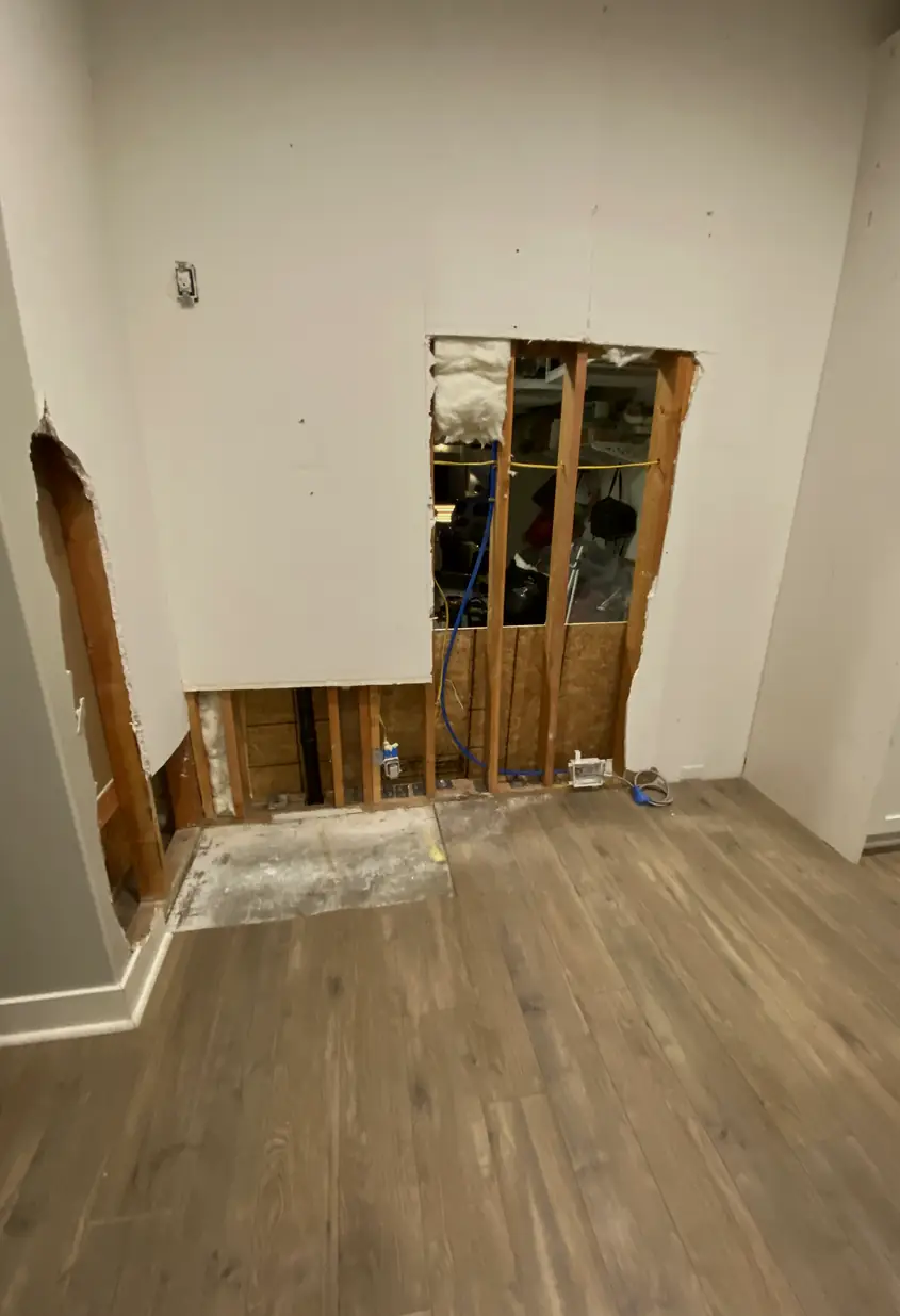 Repaired drywall where a large hole once was, now a smooth, flat surface with seamless blending and even natural light reflection.