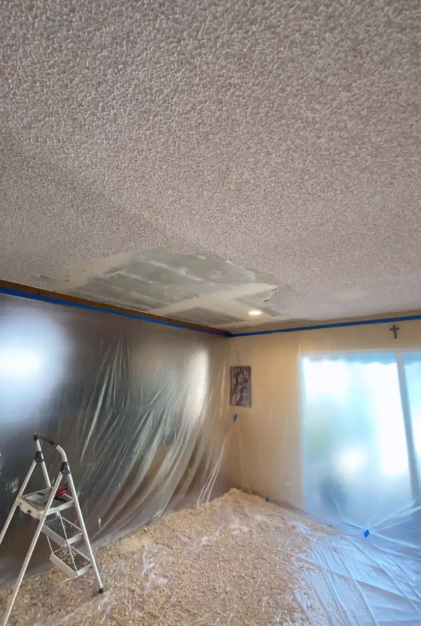 Repaired drywall with a patched hole now flat and smooth, blended seamlessly into the surrounding wall under natural light.
