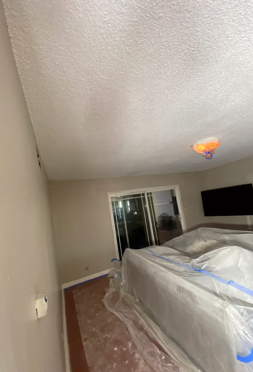 Wall hole patched and skimmed smooth, surface blended perfectly with no visible seams or shadows in Stanton repair.