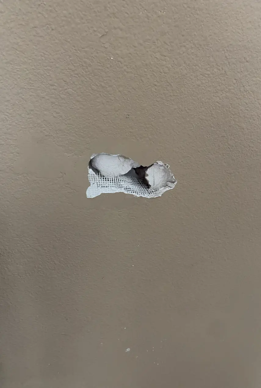 Drywall hole patched and skimmed in Tustin, surface smooth and even with no visible seams or shadows.