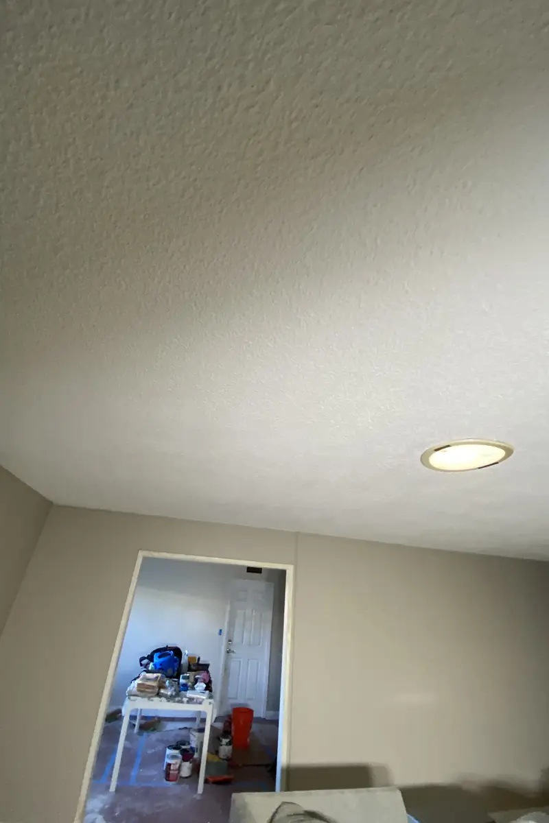 Repaired drywall patch where a large hole was rebuilt and skimmed to a smooth, even surface with no visible seams or shadows.